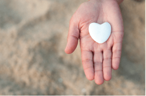 image of a hand holding an heart